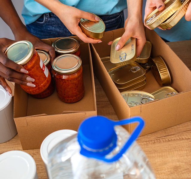 people putting items in a box